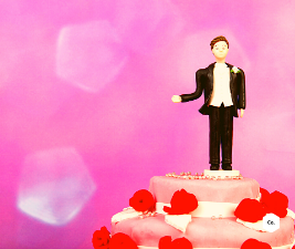 Conceptual image of a wedding cake topped with only a groom