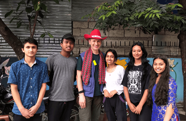 Group photo of Taras Kulish and vocational students of HOPE worldwide Nepal's Asha Vidhyashram School standing outside