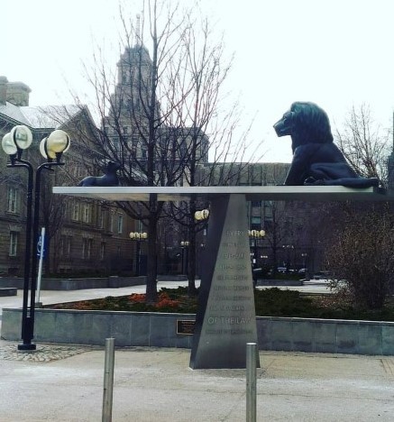 A lion and lamb on a balanced scale statue.